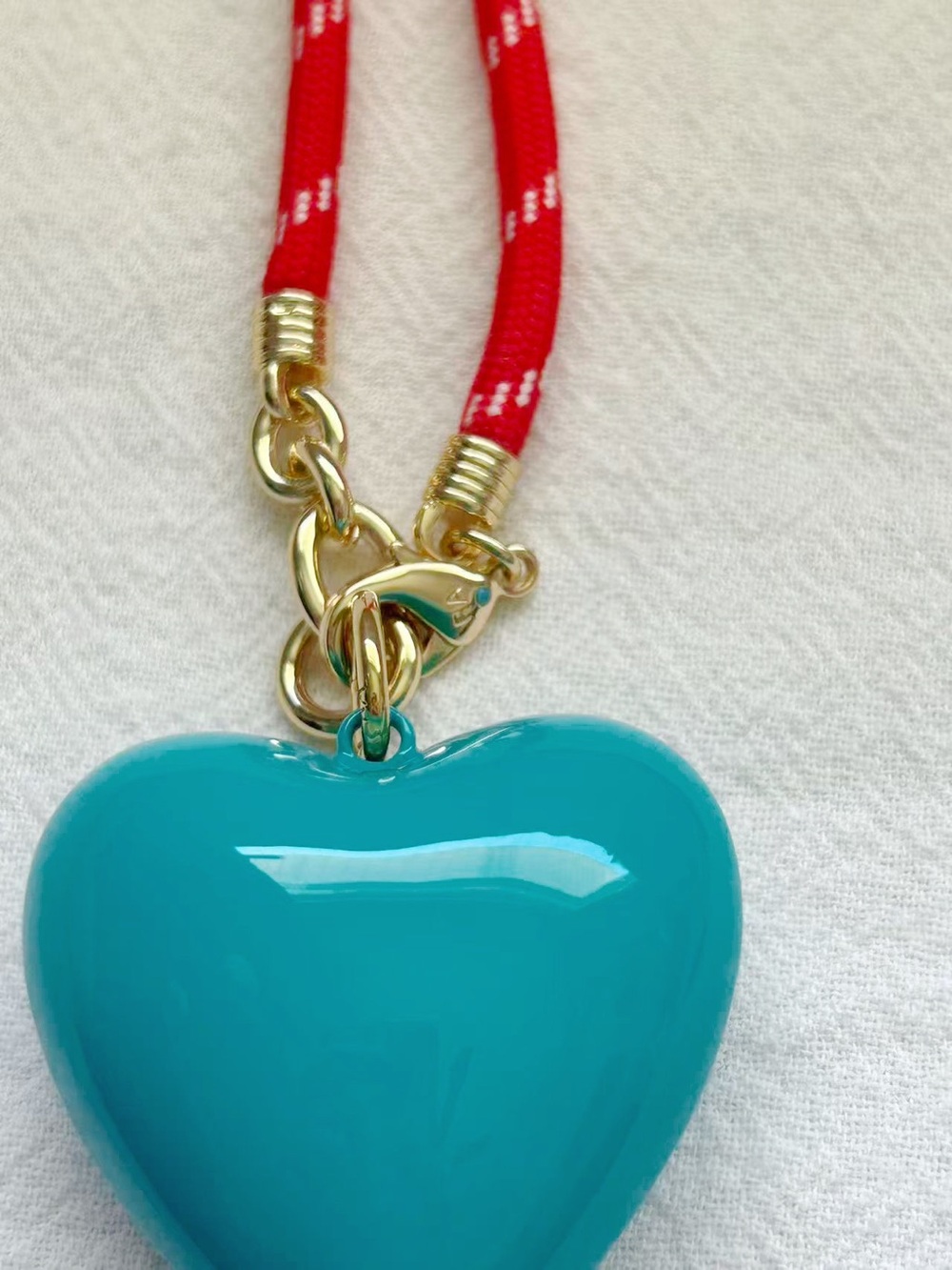 Roxanne Assoulin Long Happy
Cord Charm
Necklace Red Cord Dark Turquoise Charm - Picture 3 of 4
